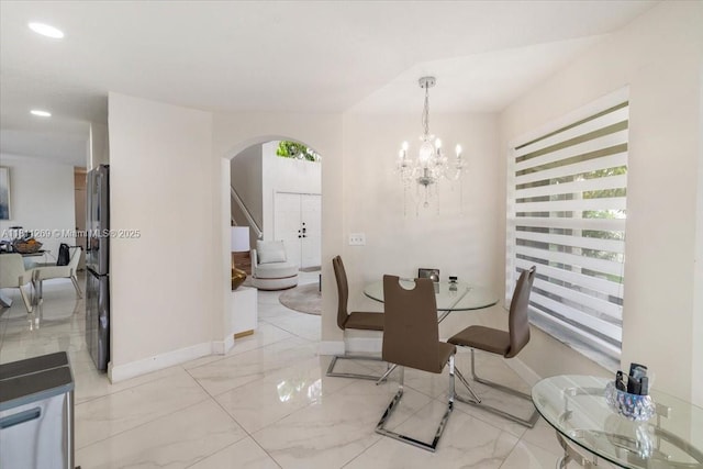 16466 SW 29th St, Miramar, FL 33027 - dining area with arched walkways, baseboards, light marble finish flooring, recessed lighting, and a chandelier