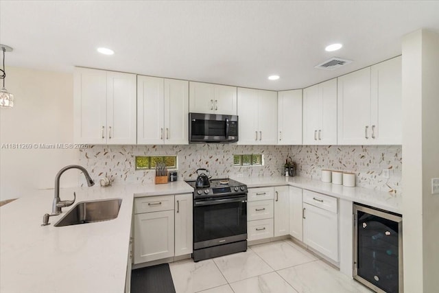 16466 SW 29th St, Miramar, FL 33027 - kitchen with appliances with stainless steel finishes, beverage cooler, a sink, light countertops, and white cabinets