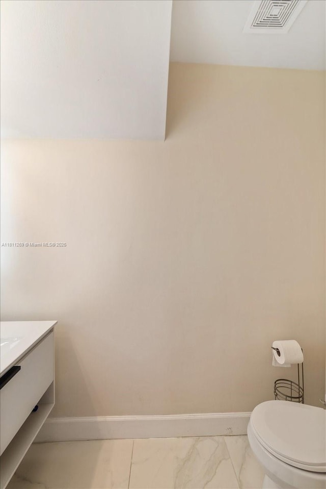 16466 SW 29th St, Miramar, FL 33027 - half bath with marble look tile flooring, vanity, baseboards, and toilet