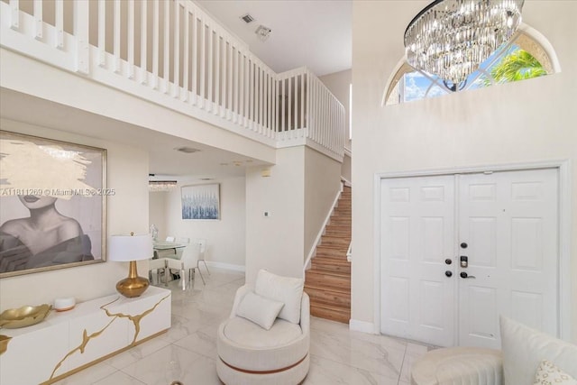 16466 SW 29th St, Miramar, FL 33027 - entrance foyer with a towering ceiling, marble look tiles, stairs, a chandelier, and baseboards