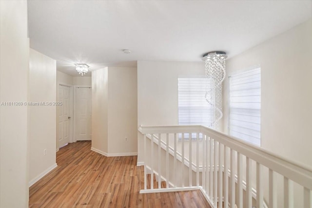 16466 SW 29th St, Miramar, FL 33027 - hall featuring an upstairs landing, wood finished floors, a chandelier, and baseboards