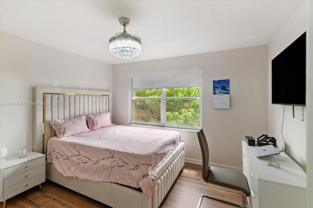 16466 SW 29th St, Miramar, FL 33027 - bedroom with wood finished floors, a chandelier, and baseboards
