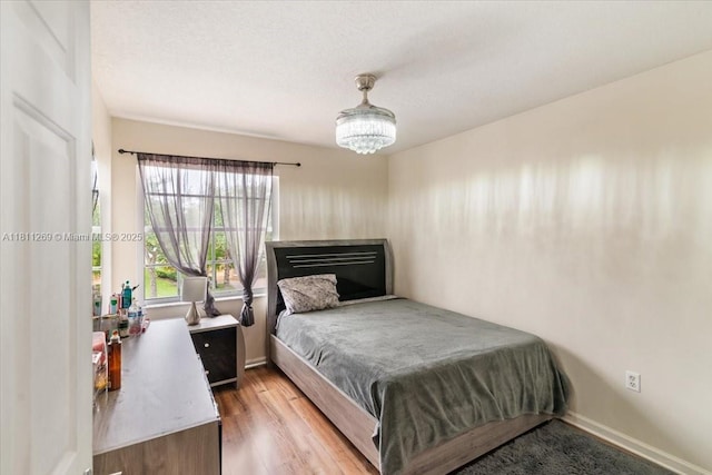 16466 SW 29th St, Miramar, FL 33027 - bedroom with a chandelier, wood finished floors, and baseboards