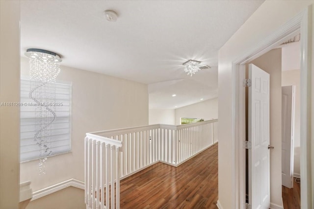 16466 SW 29th St, Miramar, FL 33027 - hallway featuring wood finished floors, an upstairs landing, and baseboards