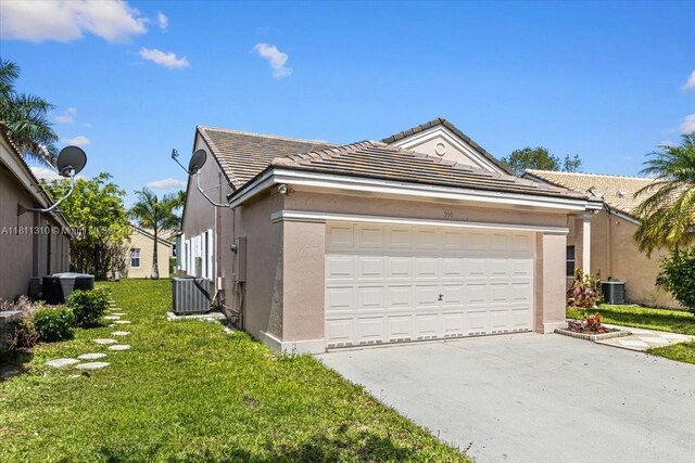 930 Briar Ridge Rd, Weston, FL 33327 - view of front of home with concrete driveway, stucco siding, a garage, cooling unit, and a front yard