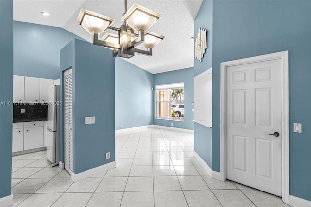 930 Briar Ridge Rd, Weston, FL 33327 - spare room featuring a chandelier, light tile patterned floors, baseboards, high vaulted ceiling, and a textured ceiling