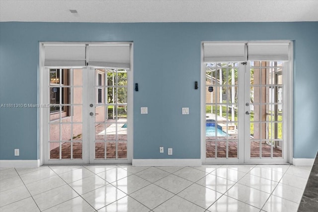 930 Briar Ridge Rd, Weston, FL 33327 - doorway to outside featuring baseboards, french doors, tile patterned flooring, and a textured ceiling