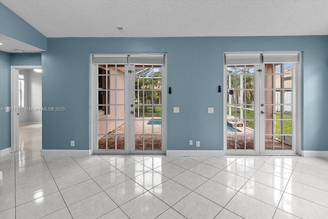 930 Briar Ridge Rd, Weston, FL 33327 - tiled spare room with a textured ceiling, baseboards, and french doors