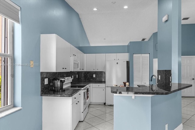 930 Briar Ridge Rd, Weston, FL 33327 - kitchen featuring white appliances, light tile patterned floors, decorative backsplash, a peninsula, and white cabinets