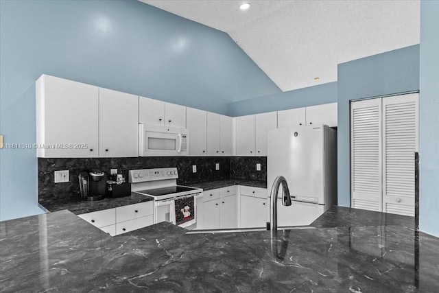930 Briar Ridge Rd, Weston, FL 33327 - kitchen featuring white appliances, backsplash, white cabinetry, dark stone counters, and high vaulted ceiling