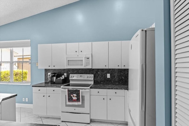 930 Briar Ridge Rd, Weston, FL 33327 - kitchen with white appliances, dark countertops, white cabinetry, tasteful backsplash, and high vaulted ceiling