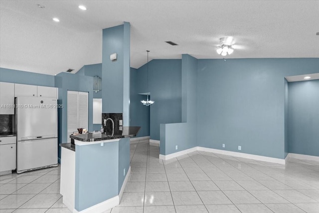 930 Briar Ridge Rd, Weston, FL 33327 - kitchen featuring freestanding refrigerator, dark countertops, lofted ceiling, a chandelier, and baseboards