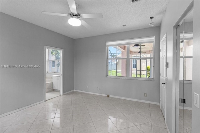 930 Briar Ridge Rd, Weston, FL 33327 - spare room with ceiling fan, baseboards, a textured ceiling, and light tile patterned floors