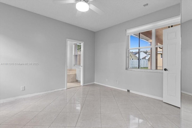 930 Briar Ridge Rd, Weston, FL 33327 - spare room with ceiling fan, baseboards, light tile patterned floors, and a textured ceiling
