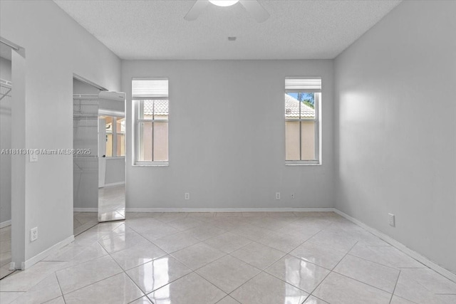 930 Briar Ridge Rd, Weston, FL 33327 - unfurnished bedroom with a textured ceiling, a closet, baseboards, ceiling fan, and tile patterned flooring