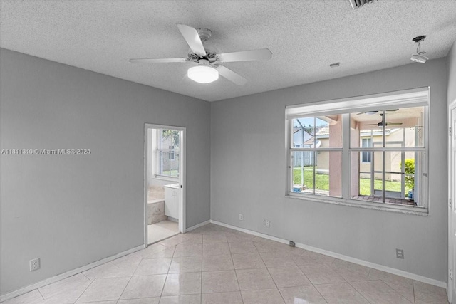930 Briar Ridge Rd, Weston, FL 33327 - spare room featuring ceiling fan, baseboards, light tile patterned floors, and a textured ceiling