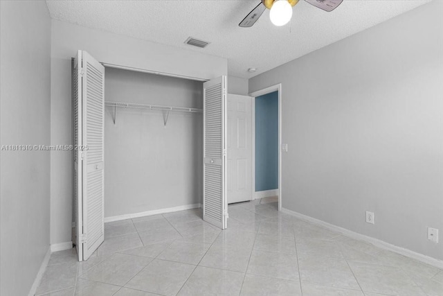 930 Briar Ridge Rd, Weston, FL 33327 - unfurnished bedroom with a closet, light tile patterned floors, a textured ceiling, a ceiling fan, and baseboards