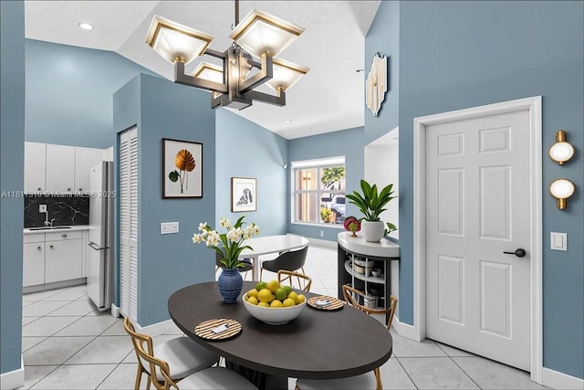 930 Briar Ridge Rd, Weston, FL 33327 - dining area featuring light tile patterned floors, baseboards, a chandelier, and high vaulted ceiling