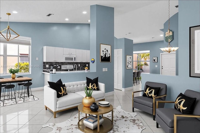 930 Briar Ridge Rd, Weston, FL 33327 - living room featuring baseboards, light tile patterned floors, high vaulted ceiling, a chandelier, and recessed lighting