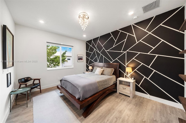 6645 NW 103rd Path, Doral, FL 33178 - bedroom with light wood finished floors, baseboards, recessed lighting, an accent wall, and a chandelier