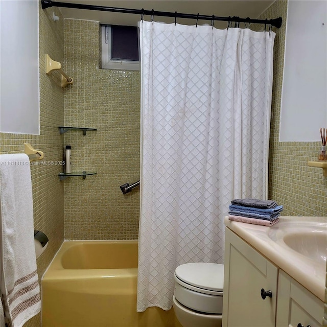 2905 Point E Dr Unit L402, Aventura, FL 33160 - bathroom featuring tile walls, vanity, toilet, shower / bath combo with shower curtain, and a wainscoted wall