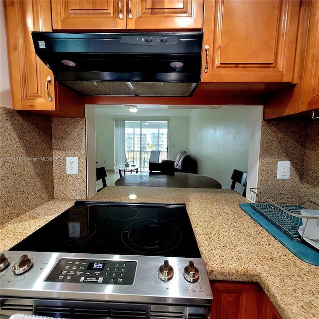 2905 Point E Dr Unit L402, Aventura, FL 33160 - kitchen with stainless steel electric range, ventilation hood, backsplash, and light countertops