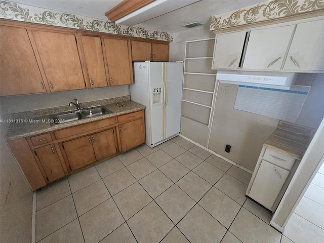 1521 Richmond Rd, Lakeland, FL 33805 - kitchen featuring white refrigerator with ice dispenser, a sink, brown cabinets, and light tile patterned floors