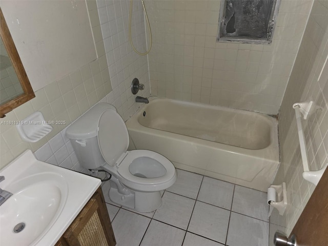 1521 Richmond Rd, Lakeland, FL 33805 - bathroom featuring tile walls, toilet, shower / washtub combination, tile patterned floors, and vanity