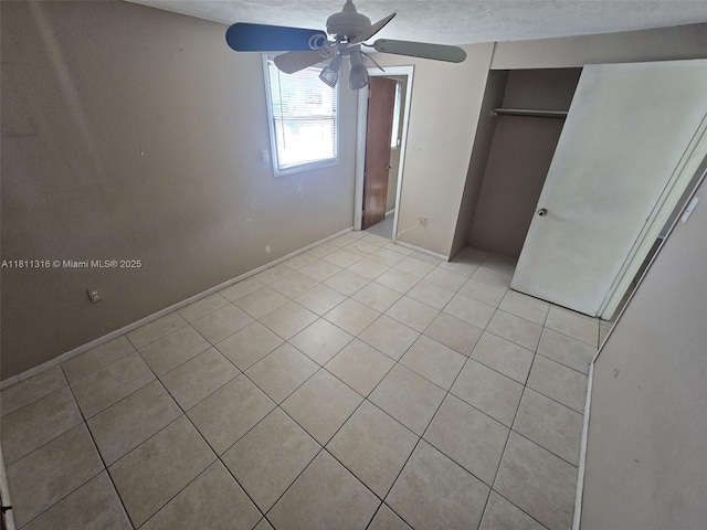1521 Richmond Rd, Lakeland, FL 33805 - unfurnished bedroom with light tile patterned flooring, a closet, ceiling fan, and baseboards