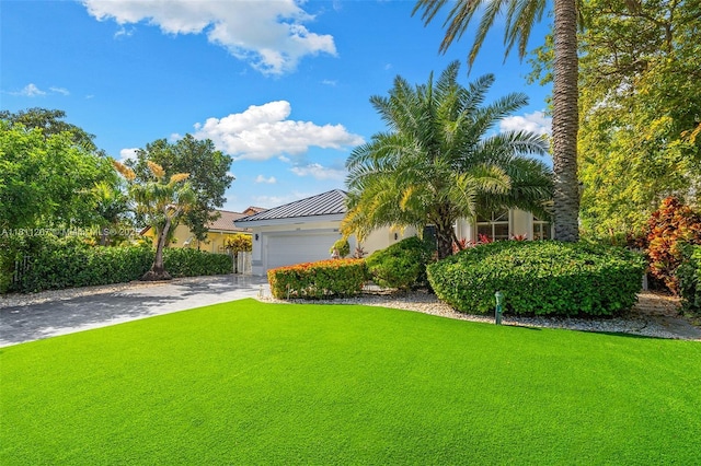 301 S Riverside, Pompano Beach, FL 33062 - view of front of home featuring driveway, stucco siding, an attached garage, and a front yard