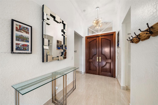 301 S Riverside, Pompano Beach, FL 33062 - entrance foyer with a chandelier, a textured wall, and light tile patterned floors
