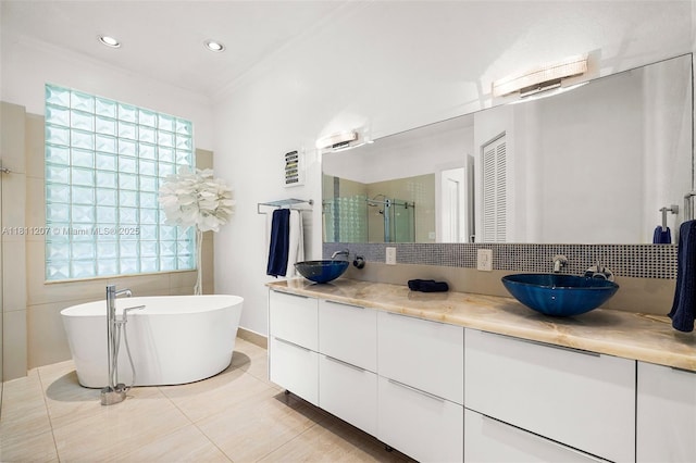 301 S Riverside, Pompano Beach, FL 33062 - bathroom featuring double vanity, a stall shower, a freestanding bath, tile patterned flooring, and recessed lighting