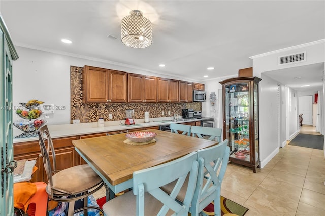 2316 SW 81st Way Unit 8, North Lauderdale, FL 33068 - kitchen featuring stainless steel appliances, tasteful backsplash, light countertops, crown molding, and light tile patterned floors