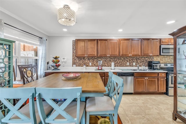 2316 SW 81st Way Unit 8, North Lauderdale, FL 33068 - kitchen featuring appliances with stainless steel finishes, brown cabinets, light countertops, ornamental molding, and backsplash