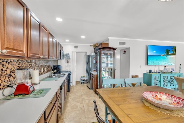 2316 SW 81st Way Unit 8, North Lauderdale, FL 33068 - kitchen with freestanding refrigerator, decorative backsplash, crown molding, range with electric cooktop, and a sink