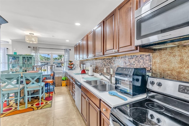 2316 SW 81st Way Unit 8, North Lauderdale, FL 33068 - kitchen featuring appliances with stainless steel finishes, a sink, tasteful backsplash, light countertops, and light tile patterned floors