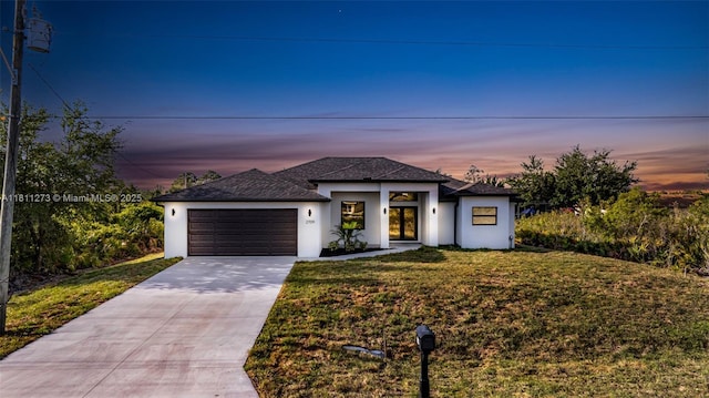 2709 58th St W, Lehigh Acres, FL 33971 - view of front of house with stucco siding, concrete driveway, an attached garage, a front lawn, and roof with shingles