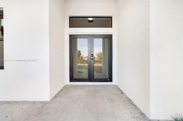 2709 58th St W, Lehigh Acres, FL 33971 - doorway to property featuring french doors and stucco siding
