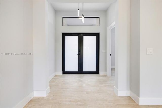 2709 58th St W, Lehigh Acres, FL 33971 - foyer entrance featuring wood finished floors, baseboards, and french doors