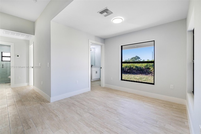 2709 58th St W, Lehigh Acres, FL 33971 - spare room with plenty of natural light, light wood-style floors, and baseboards