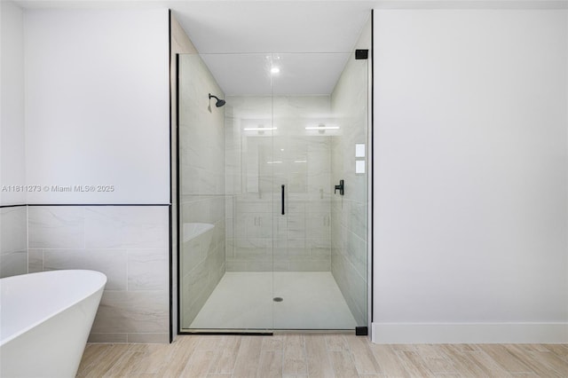 2709 58th St W, Lehigh Acres, FL 33971 - bathroom with a shower stall, wood finished floors, a soaking tub, and recessed lighting