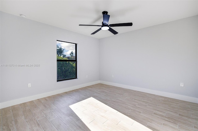 2709 58th St W, Lehigh Acres, FL 33971 - unfurnished room with light wood-style floors, ceiling fan, baseboards, and a smoke detector