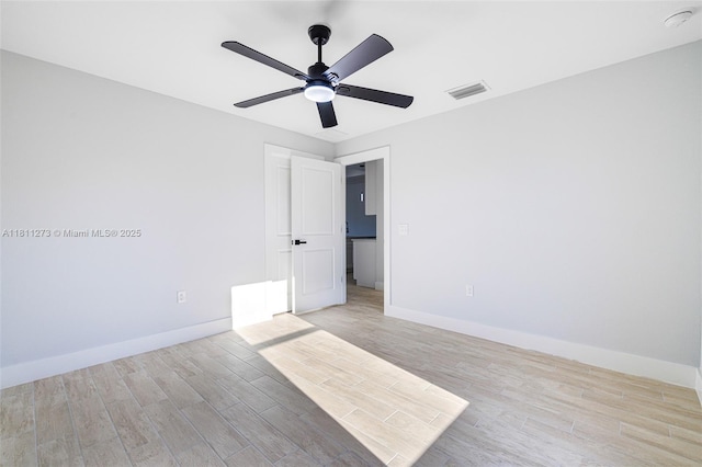 2709 58th St W, Lehigh Acres, FL 33971 - spare room with light wood-style floors, baseboards, ceiling fan, and a smoke detector