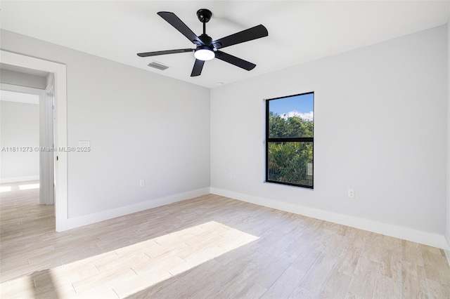 2709 58th St W, Lehigh Acres, FL 33971 - unfurnished room with wood finished floors, baseboards, and ceiling fan