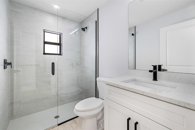 2709 58th St W, Lehigh Acres, FL 33971 - full bathroom featuring vanity, toilet, a stall shower, and wood finished floors