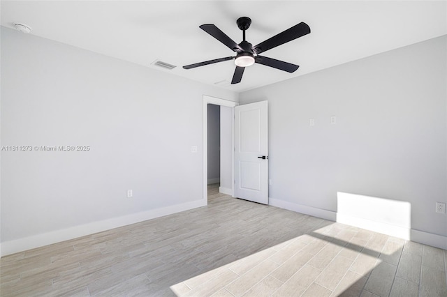 2709 58th St W, Lehigh Acres, FL 33971 - unfurnished room with light wood-type flooring, baseboards, a ceiling fan, and a smoke detector