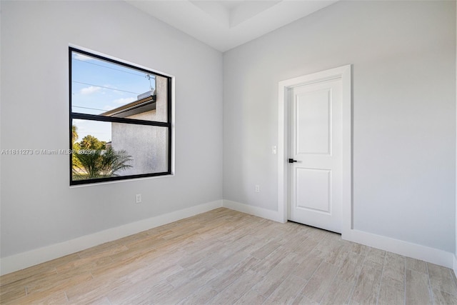 2709 58th St W, Lehigh Acres, FL 33971 - unfurnished room with wood finished floors and baseboards