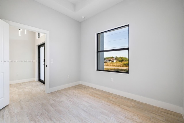 2709 58th St W, Lehigh Acres, FL 33971 - empty room featuring light wood-style floors and baseboards
