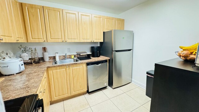 5122 NW 79th Ave Unit 301, Doral, FL 33166 - kitchen with appliances with stainless steel finishes, light brown cabinetry, a sink, light tile patterned flooring, and light countertops