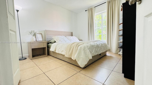 5122 NW 79th Ave Unit 301, Doral, FL 33166 - bedroom featuring light tile patterned flooring and baseboards